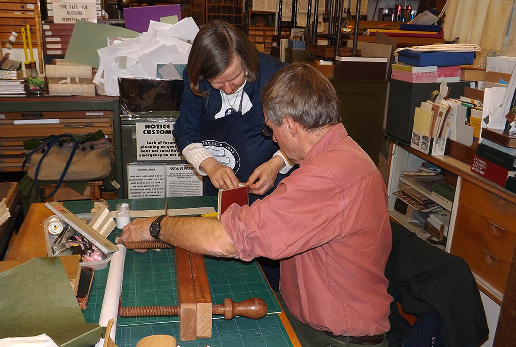 Mary Bartlett and a student in her bookbinding class