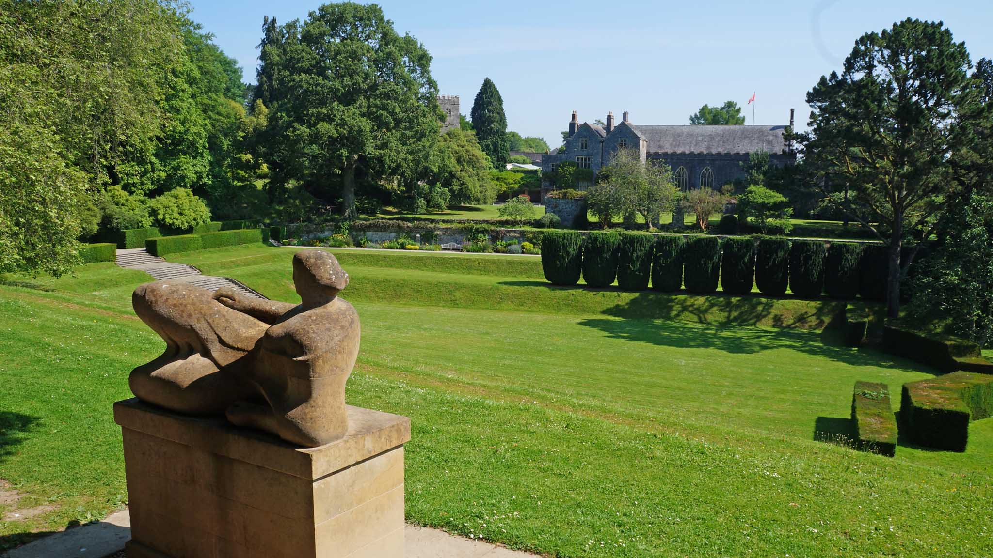 Dartington Hall's Tiltyard area, with Henry Moore's Reclining figure sculpture in the foreground and Great Hall in the background